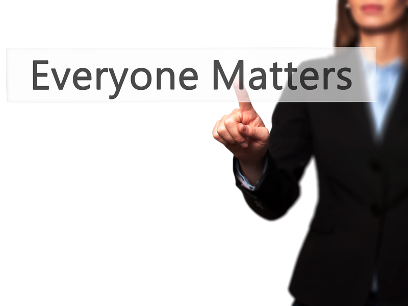 Concept image of woman with suit pointing to Everyone Matters text.