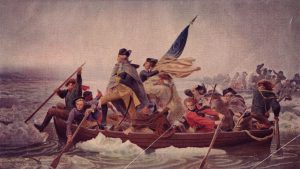 Painting of George Washington Crossing the Delaware in a rowboat full of troops. He is stood in the front of the boat with a furled American Flag.
