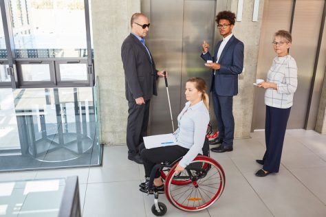 Employee resource group with disabled workers waiting for the elevator.