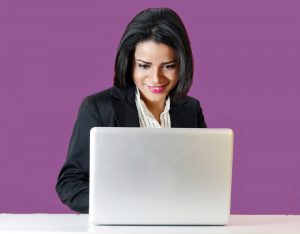 woman happily working at a laptop for PDF Remediation not Print to PDF