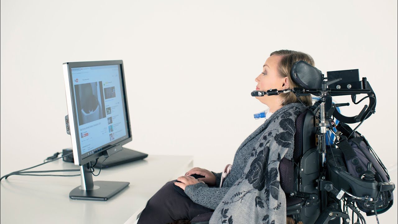 woman in a wheelchair using eye tracking software. 