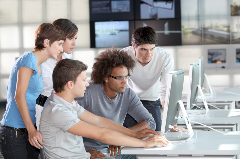 team collaborating around a computer